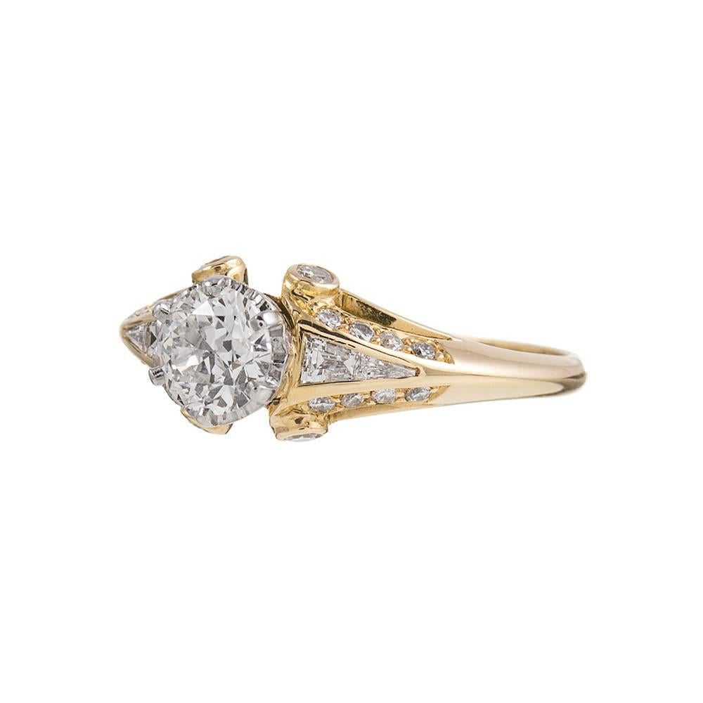 Charming ring made of 18k yellow gold with an 18k white gold crown shaped basket to hold the center stone. The major diamond is accompanied by an EGL diamond grading certificate that describes the diamond as H color and Vs1 clarity. An additional 36