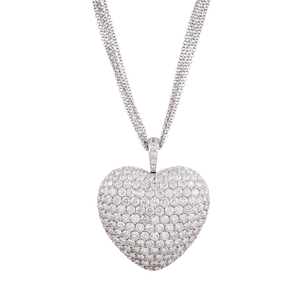 Measuring just shy of 1.5 inches square, this diamond heart pendant will dazzle from afar, as it is fully encrusted with an impressive 16.50 carats of brilliant white diamonds. The three dimensional pendant is suspended from a five strand 18k white