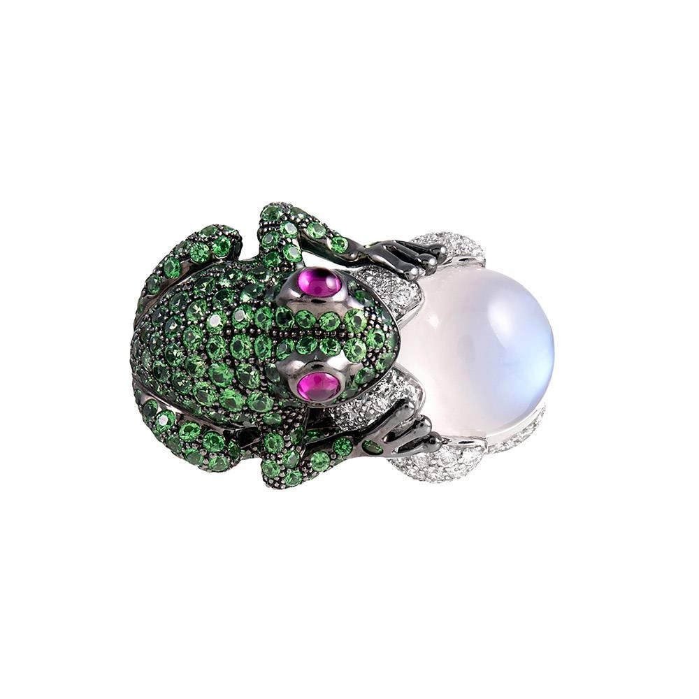 A charming organically themed creation, compliments of iconic French jewelry house Boucheron. Made of 18k white gold, the tsavorite garnet encrusted frog has cabochon ruby set eyes and has been enhanced by black rhodium. The grenouille is grasping a
