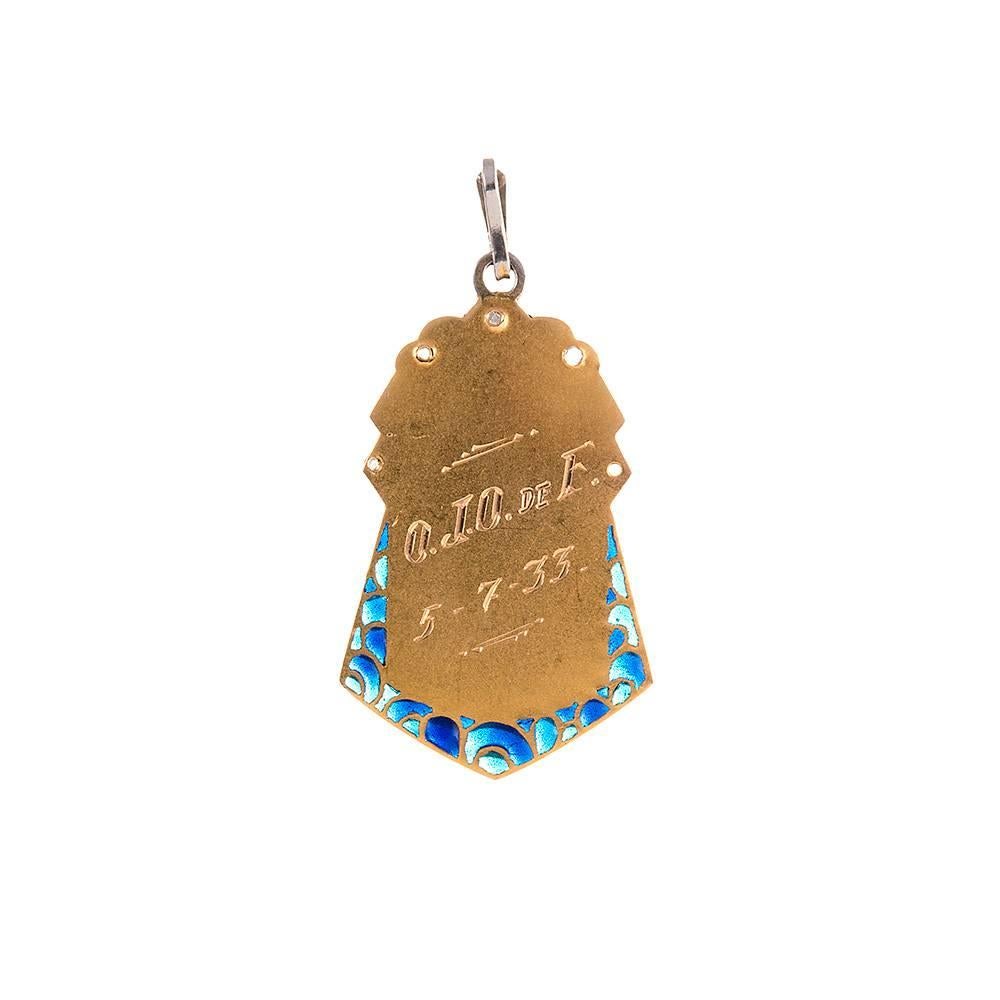 Made of 18k yellow gold and platinum and decorated with enamel and modest diamond accents, the sweet pendant measures 1 ¼ by 5/8 inches. The back is engraved “O.J.O. de F.” and dated 5-7-33. What a charming treasure! Kindly have a look at its