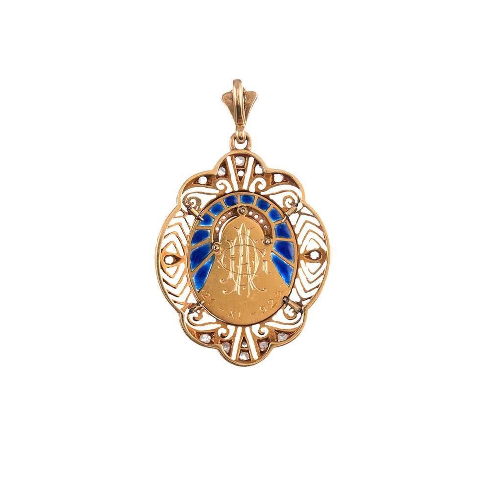 Made of 18k yellow gold and platinum and decorated with enamel and diamond accents, the sweet pendant measures 1.5 by 1 inch. The back is engraved 