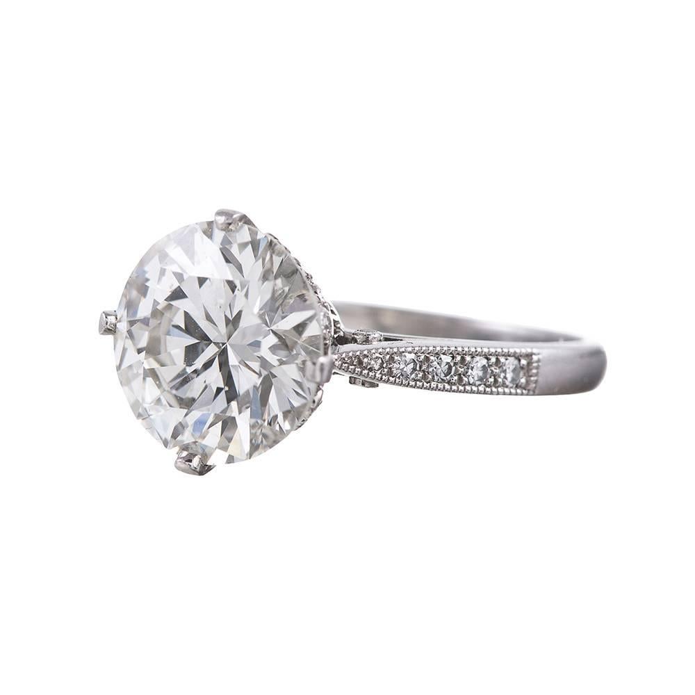 A genuine classical beauty, featuring a 3.71 carat round diamond set in a platinum mounting. The diamond is accompanied by a GIA diamond grading report stating J color and Vs2 clarity. The mounting offers just enough detail to distinguish it,