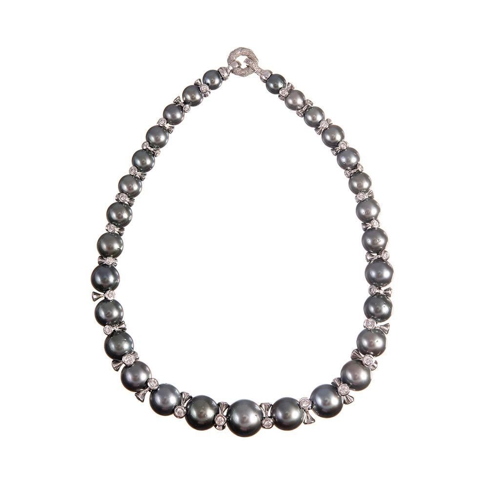 A stunning creation, combining 29 Tahitian South Sea pearls with stylized rondelles of 14k white gold that are decorated with diamonds. The subtle manner in which the diamonds have been incorporated into the design tempers the drama of the necklace,