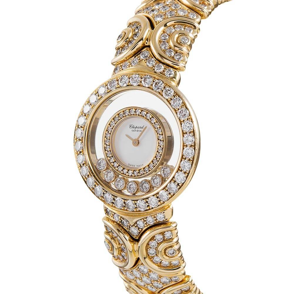 18k yellow gold Chopard cuff style bracelet watch decorated with a symmetrical pattern of polished golden strokes and extensively set with brilliant white diamonds. There are a total of 297 diamonds adorning this stunning watch. The bezel and dial