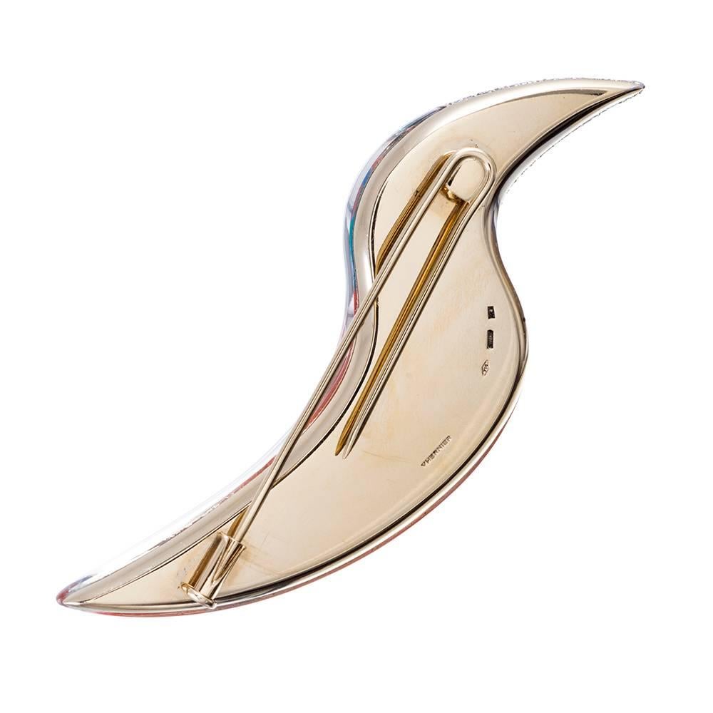 Stylized to resemble a toucan, this three-dimensional brooch is created by pairing sections of opals, covered in clear rock crystal and finished with a diamond beak and wing, resulting in a unique stroke of jewelry genius. Signed 