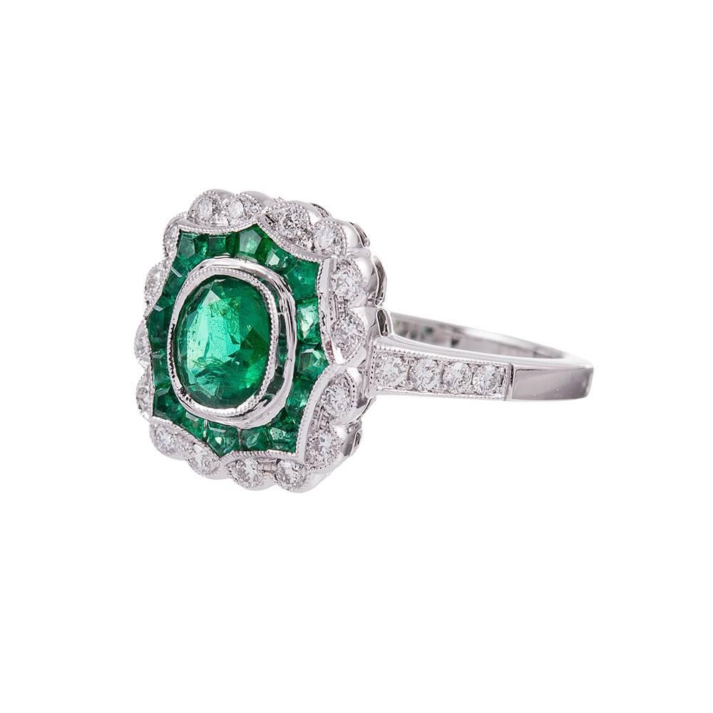 Art deco inspired, yet newly made, this ring possesses a vintage aesthetic and the physical integrity of a contemporary piece- a wonderful combination for daily wear. 1.10 carats of emeralds and .26 carats create a beautiful design with an