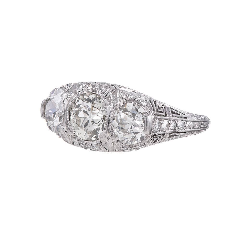 Conceived as a combination of art deco influence on a classic Victorian design, pairing three major round old European cut diamonds in an English carved style platinum mounting in masterful filigree splendor. This setting style is gorgeous from all