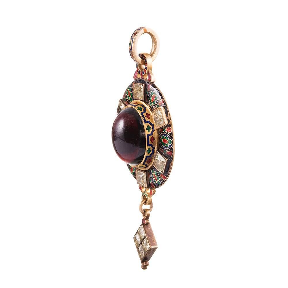 Absolutely stunning from every angle, this heavily engraved and finely decorated locket pendant becomes more beautiful the closer you look. A detailed enamel pattern with rich jewel-toned red, green and blue hues is complimented by a large oval