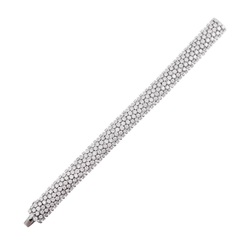 A flexible 18k white gold bracelet adorned with an impressive 28 carats of white diamonds. The piece has an incredible hand and drapes effortlessly around the wrist, creating a sensual and sophisticated experience. 7.5 inches long.
 
If you are
