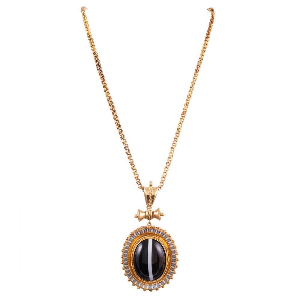 Granulation... glorious granulation! Look closely to appreciate the incredible amount of labor that was required to create this stunning oversized Victorian treasure. A large cabochon banded agate is framed in a multi-textured bezel with