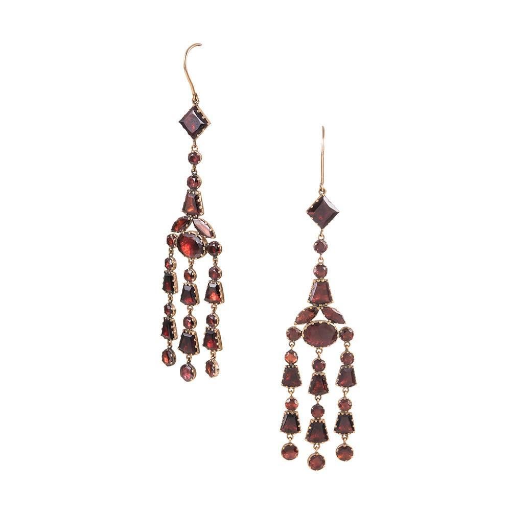 An astounding pair of antique earrings, conceived during the Georgian period, circa 1830. We have never seen earrings form this era in such a striking size; the earrings measure nearly 4 inches in overall length, swinging beautifully form your ears