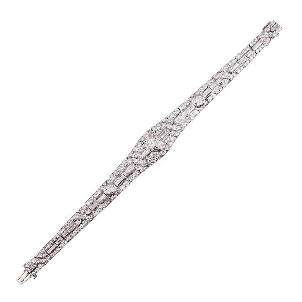 8.80 Carats of round brilliant-, marquis-, and emerald cut diamonds set in platinum and assembled in grand art deco fashion. Designed for a petite wrist, this bracelet measures just over 6.5 inches in length and is finished with a safety chain. Note