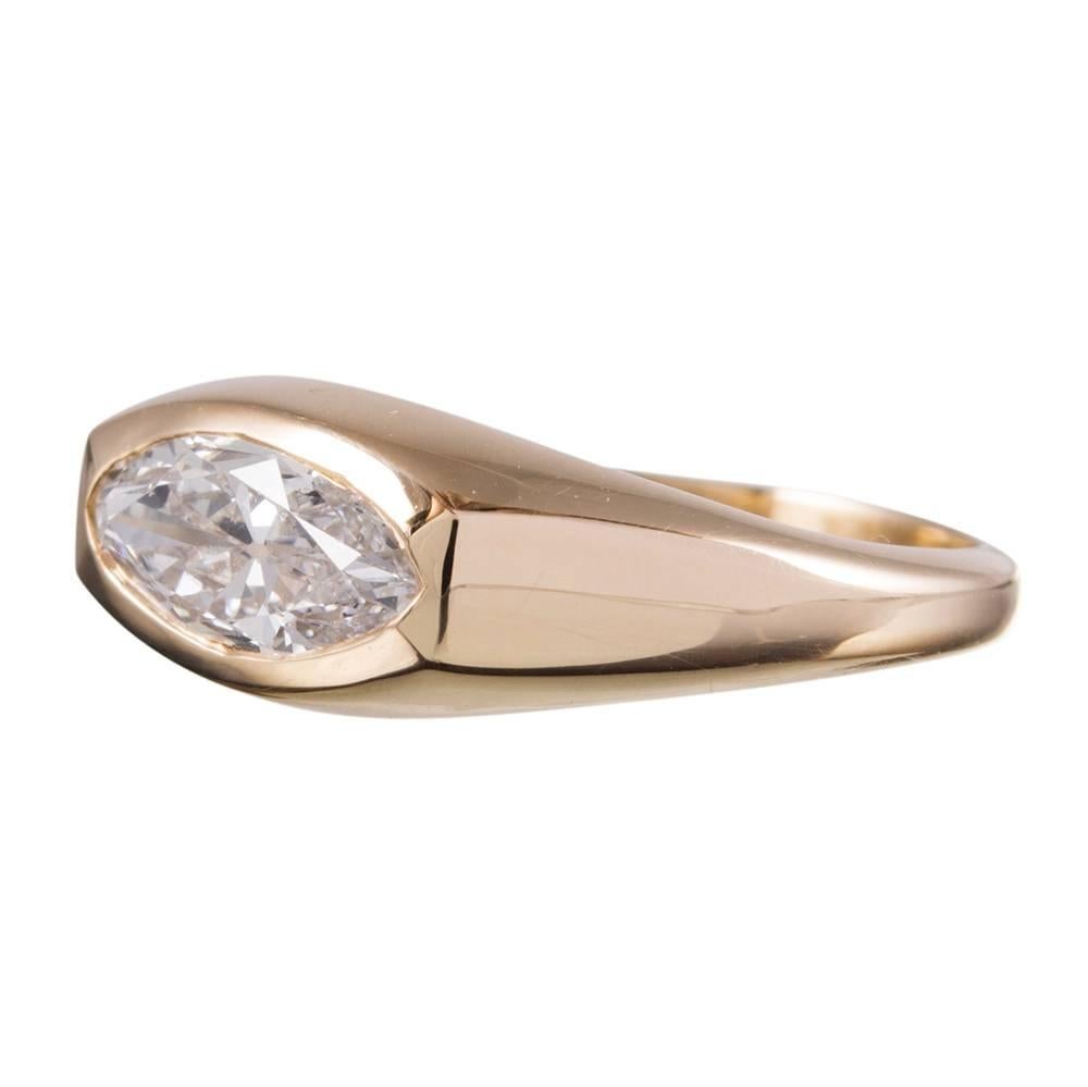 A sweet and unusual ring, rendered in 14k yellow gold and set with a 1.08 carat marquis diamond. The stone is set "east-to-west" and nestled nicely into its golden mounting, making this an ideal piece to be worn daily. This would make a