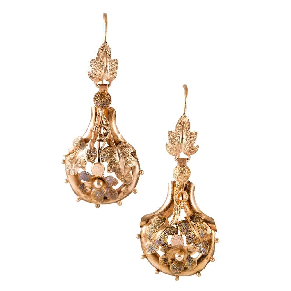 A charming set of drop earrings and a pin/pendant with a lovely textured design of leaves and flowers. The earrings are made of 14k yellow gold and measure 1.75 inches long. Light and airy, these can be worn comfortably from day to evening. The