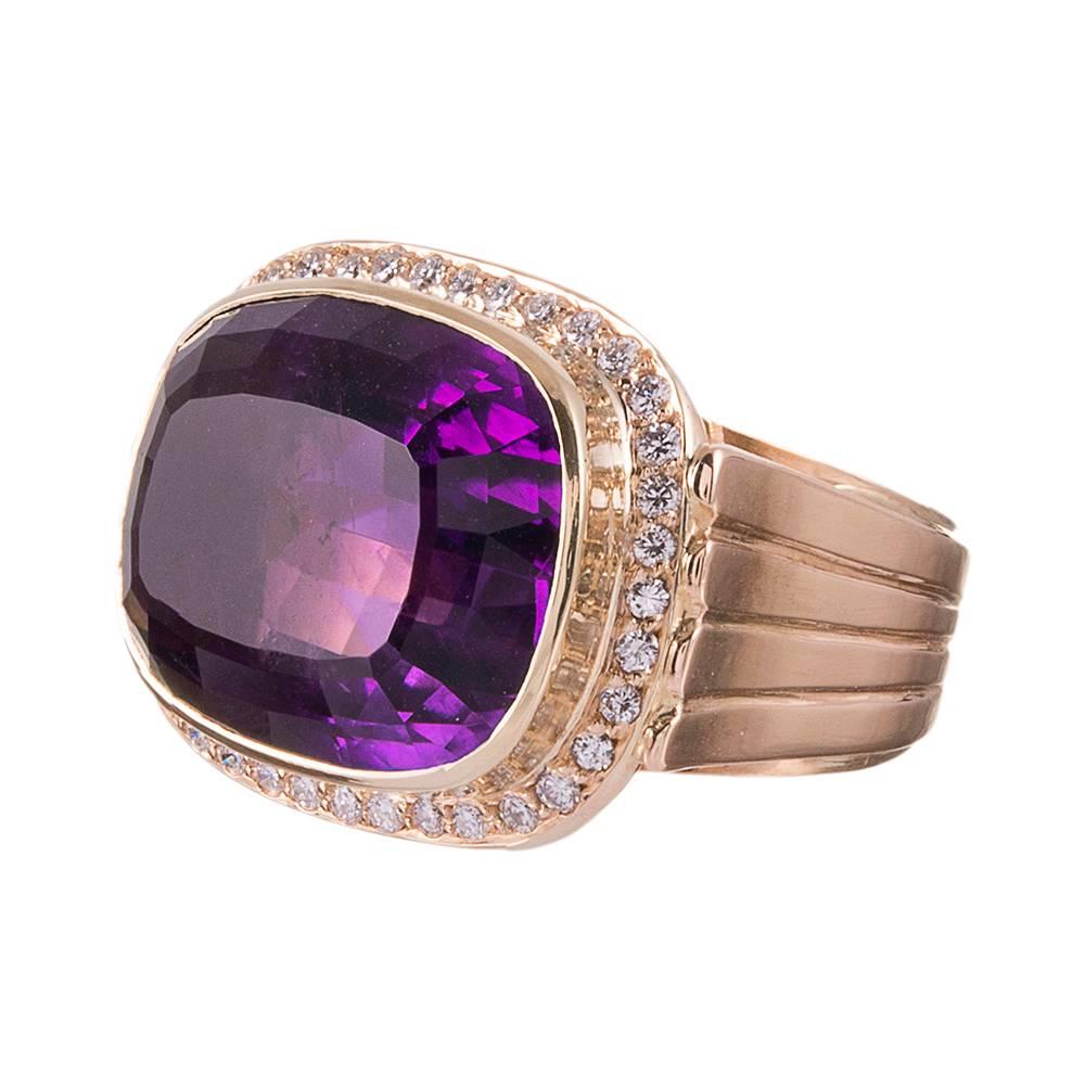 Made of 14k yellow gold and made in a style suitable for a lady or a gentleman, the center is set with a faceted elongated cushion-shaped amethyst. The stone is striking, weighing approximately 20 carats, with intense color and a truly superior gem