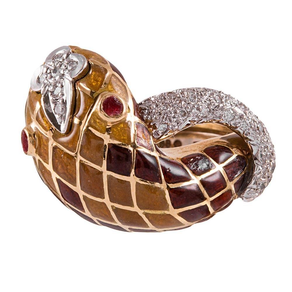 Rich color hues decorate this lifelike snake ring as its body encircles your finger with a harlequin pattern of enamel and diamonds. Rubies glisten in his eyes and compliment the golden mustard and reddish brown shades of his "scales". The
