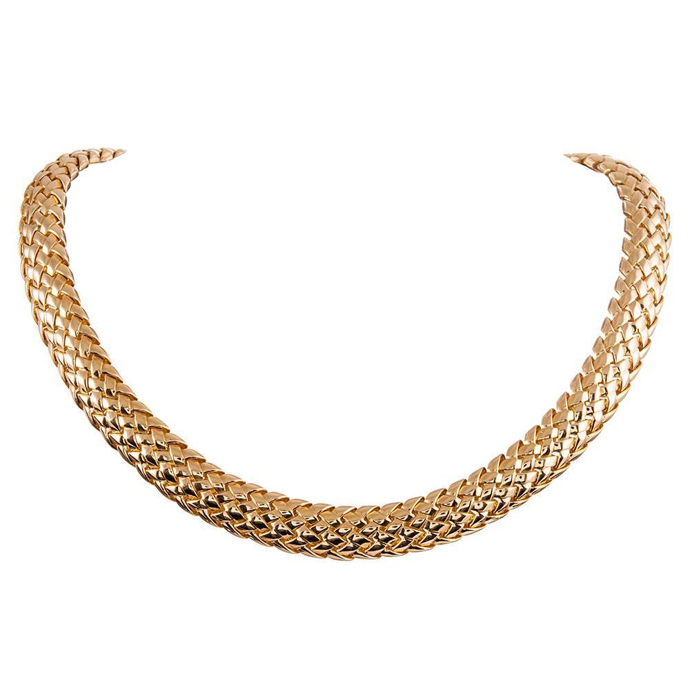 A sophisticated and highly wearable suite, consisting of a collar and bracelet, both pieces signed by Tiffany & Co. and made of 18k yellow gold. The bracelet measures 7.25 inches long and just under a half inch wide, while the necklace measures