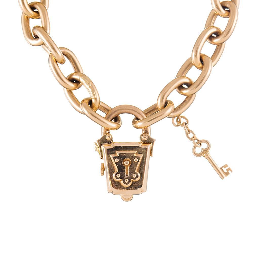 "Have you the key to my heart?"... A romantic motif creates a truly unique twist on a classic charm bracelet, with an asymmetrical lantern shaped manual wind watch suspended from a chain of oval yellow gold links. Crafted of 18k yellow