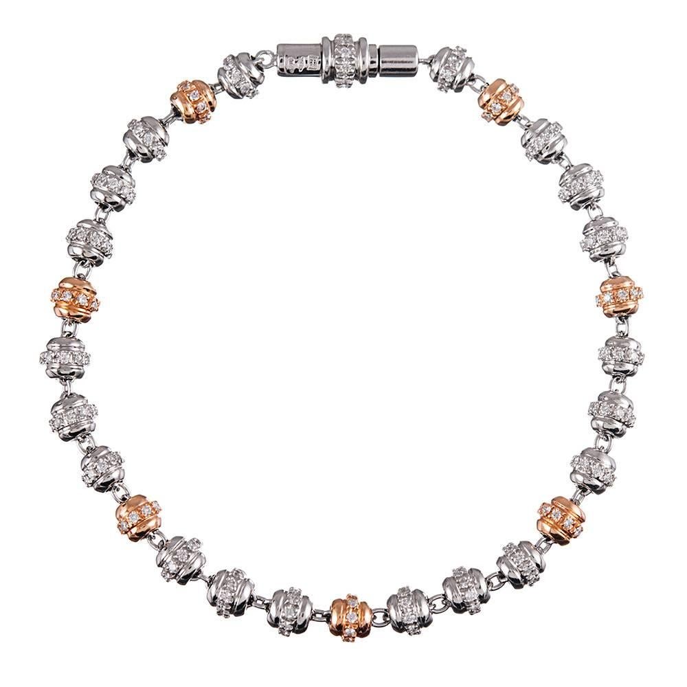 Playful fine jewelry is such a joy! This bracelet consists of rows of white and rose gold orbs, set with brilliant white diamonds (1.40 carats) and finished with a diamond-studded clasp. It is substantial enough to wear on its own, but would also