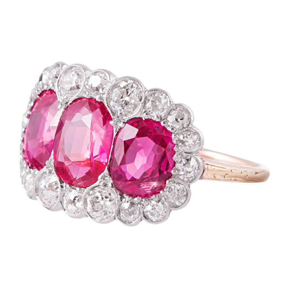 An heirloom quality treasure that will not go unnoticed, the ring is designed as a trip of oval faceted rubies set in a frame of brilliant white diamonds. The mounting is made of 18k yellow gold and platinum- classic Edwardian! Despite its