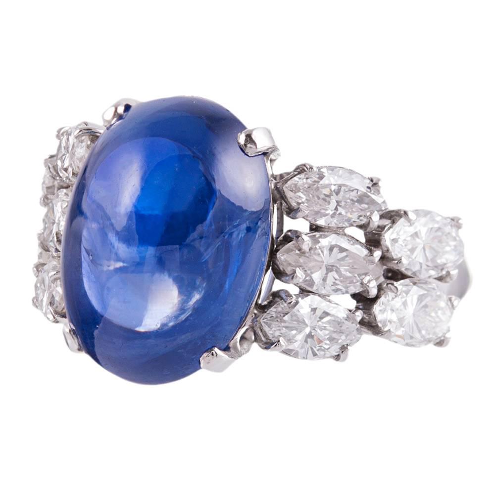 A beautiful mid-century treasure, rendered in platinum and set in the center with a 12.46 carat sugarloaf sapphire. The accompanying GIA gemstone report describes the stone as being of Ceylon origin and without any indication of heat treatment. The