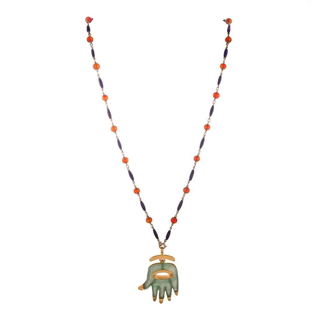 A chic means of warding off evil spirits, this Hamsa pendant is carved of green aventurine, set in 18k yellow gold and signed 
