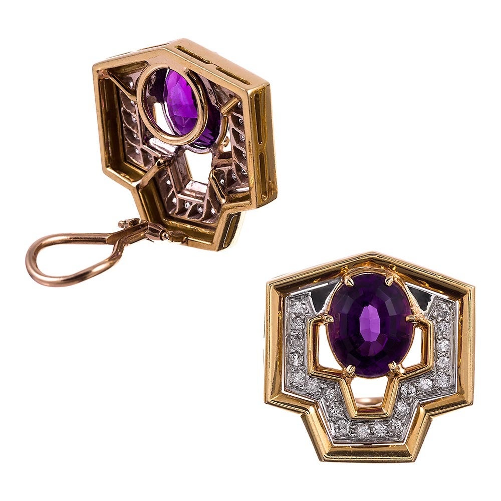 18k yellow gold earrings, a unique nine-sided shield shape, set in the center with an oval faceted amethyst and framed in brilliant white diamonds. The diamonds weigh .80 carats in total. Currently clips, a post can easily be added for those with