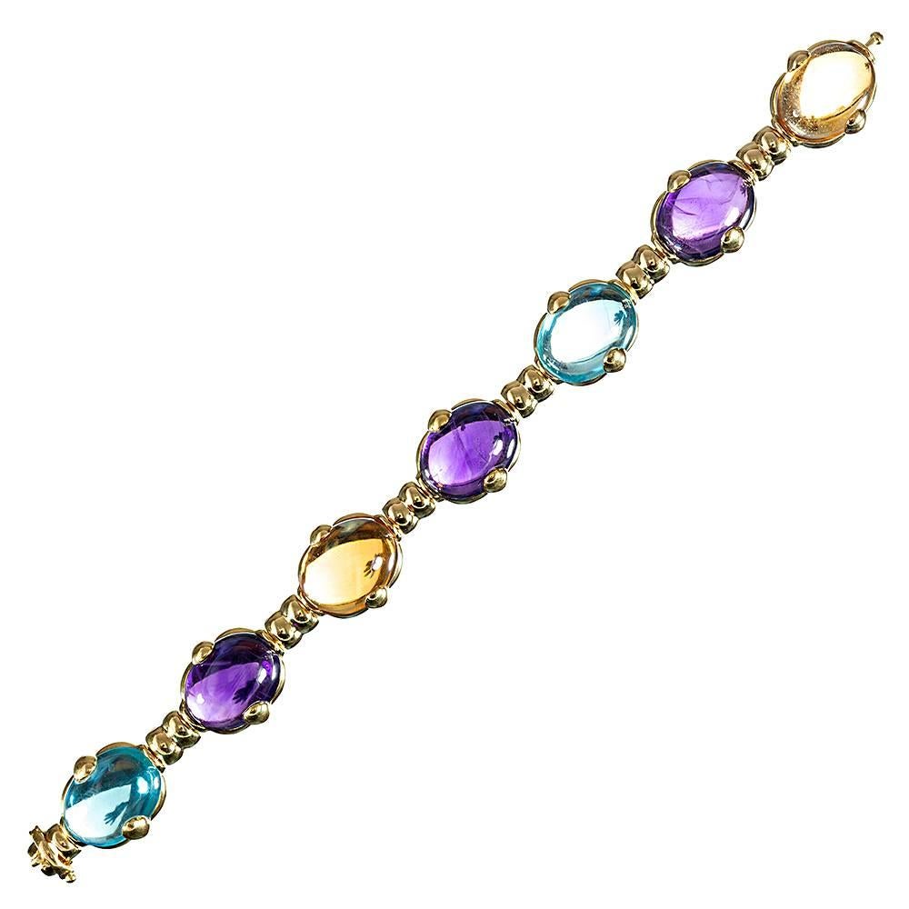Sophisticated style, the absence of diamonds allowing for easy, daytime wear, this 7.25 inch bracelet is made of 18k yellow gold and appointed with seven cabochons of colored gemstones: amethyst, citrine & aquamarine are an uncommon, yet symbiotic