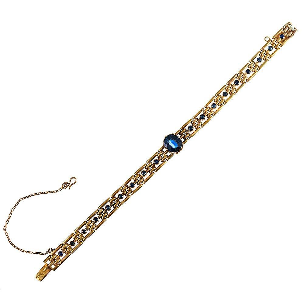Made of 18k yellow gold and boasting Russian hallmarks, the bracelet is set in the center with a 2.50 carat natural blue sapphire. The center of each polished link is enhanced with a small cabochon sapphire to complete the design. 6.75 inches long