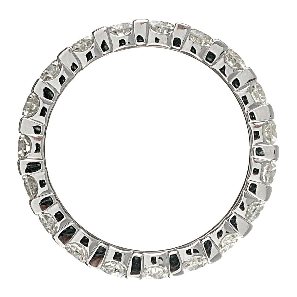 14 karat white gold ring set with three connected rows of brilliant white diamonds. The stones weigh approximately 10 carats in total and they sparkle like mad! The ring boasts a smooth interior, making it very comfortable on the hand. Size 7 can be