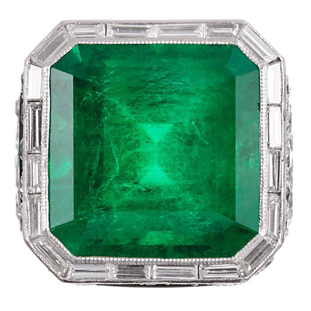 An absolutely magnificent and exclusive gem that would suit the preference of the most elite of jewelry collectors, this unique and entirely striking ring is an absolute masterpiece. The major stone is a most impressive 15.35 carat emerald. The
