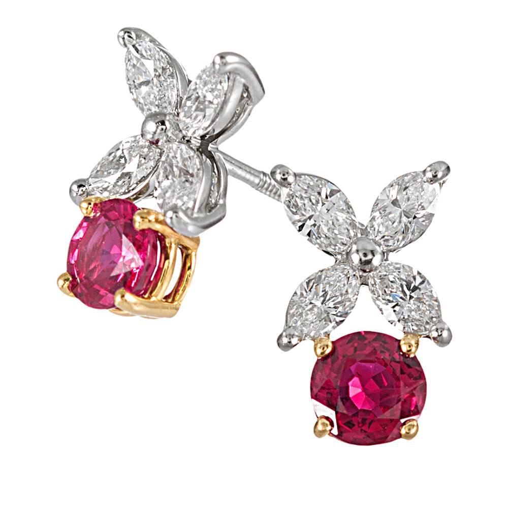Made of platinum & 18 karat yellow gold, the earrings contain .88 carats of white marquis diamonds and 1.00 carat of rubies. Fitted as posts with screwbacks, the earrings weigh 3.4 grams total weight and measure 12.5mm x 7.5mm