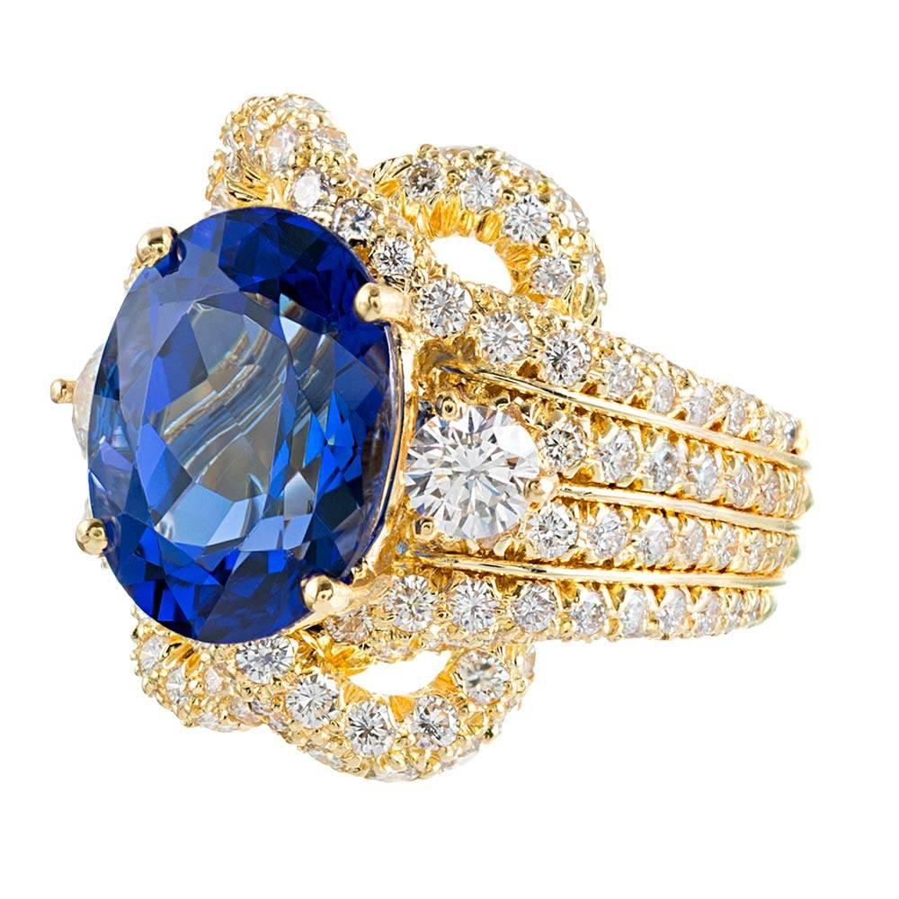 An important, bright and impressive creation, compliments of iconic American jeweler Henry Dunay. Brilliant diamonds, 2.41 carats in total, cascade down the shoulders and dance around the major center tanzanite. The center stone exhibits gem fine