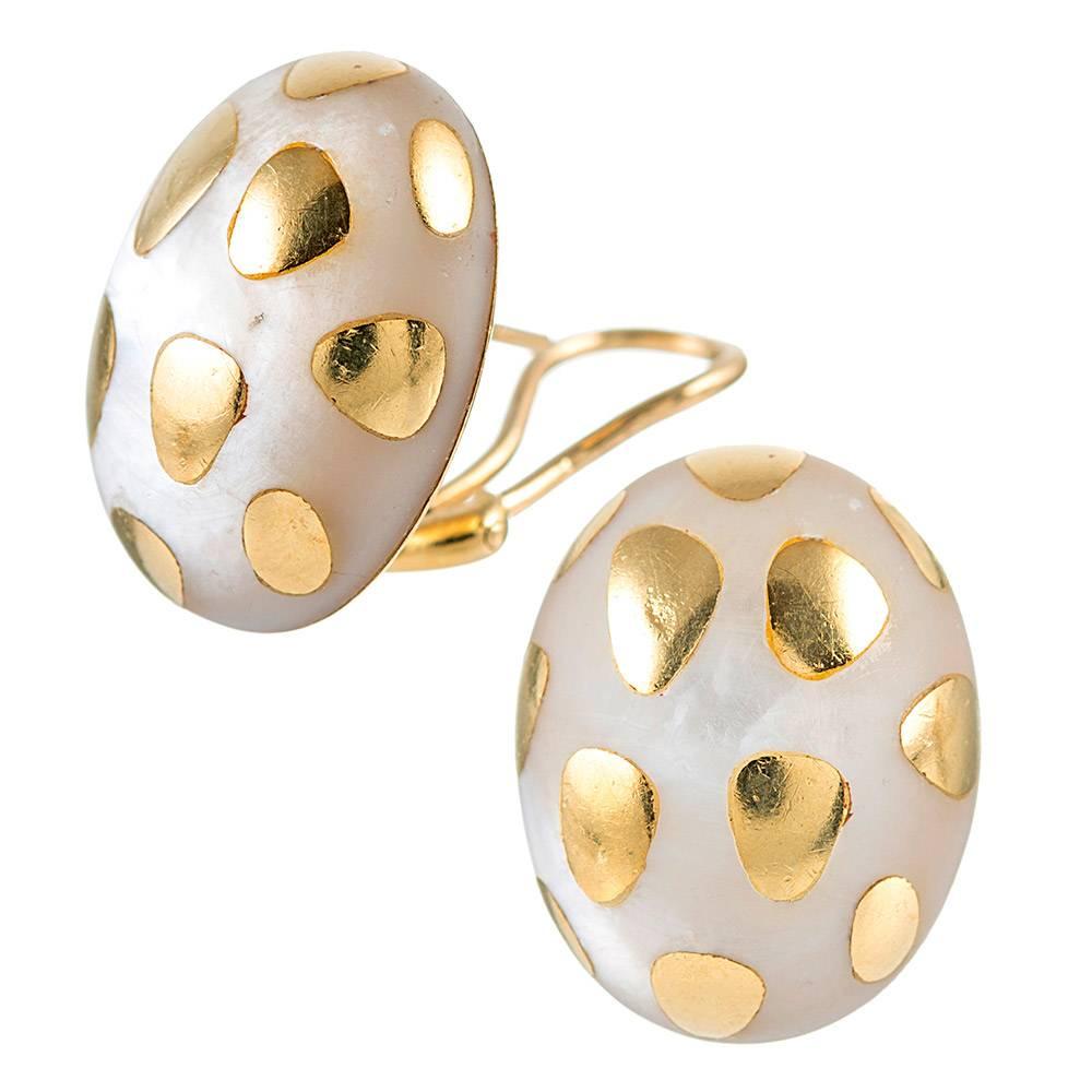 Measuring a hint under 1 inch by just under ¾ of an inch, the egg-shaped earrings are created of white mother of pearl and spotted with a pattern of 18 karat gold. Designed by Angela Cummings and signed Tiffany & Co. Currently fitted for pierced