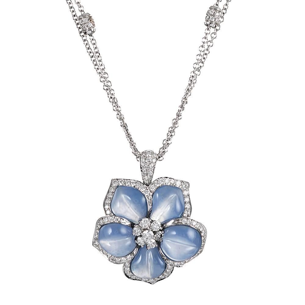 Alluring and mystical, the petals of this lifelike flower are carved of periwinkle blue-lavender chalcedony and enhanced by brilliant white diamonds. The pendant is 1.5 inches long including the bale and 1.25 inches wide. It is suspended form a