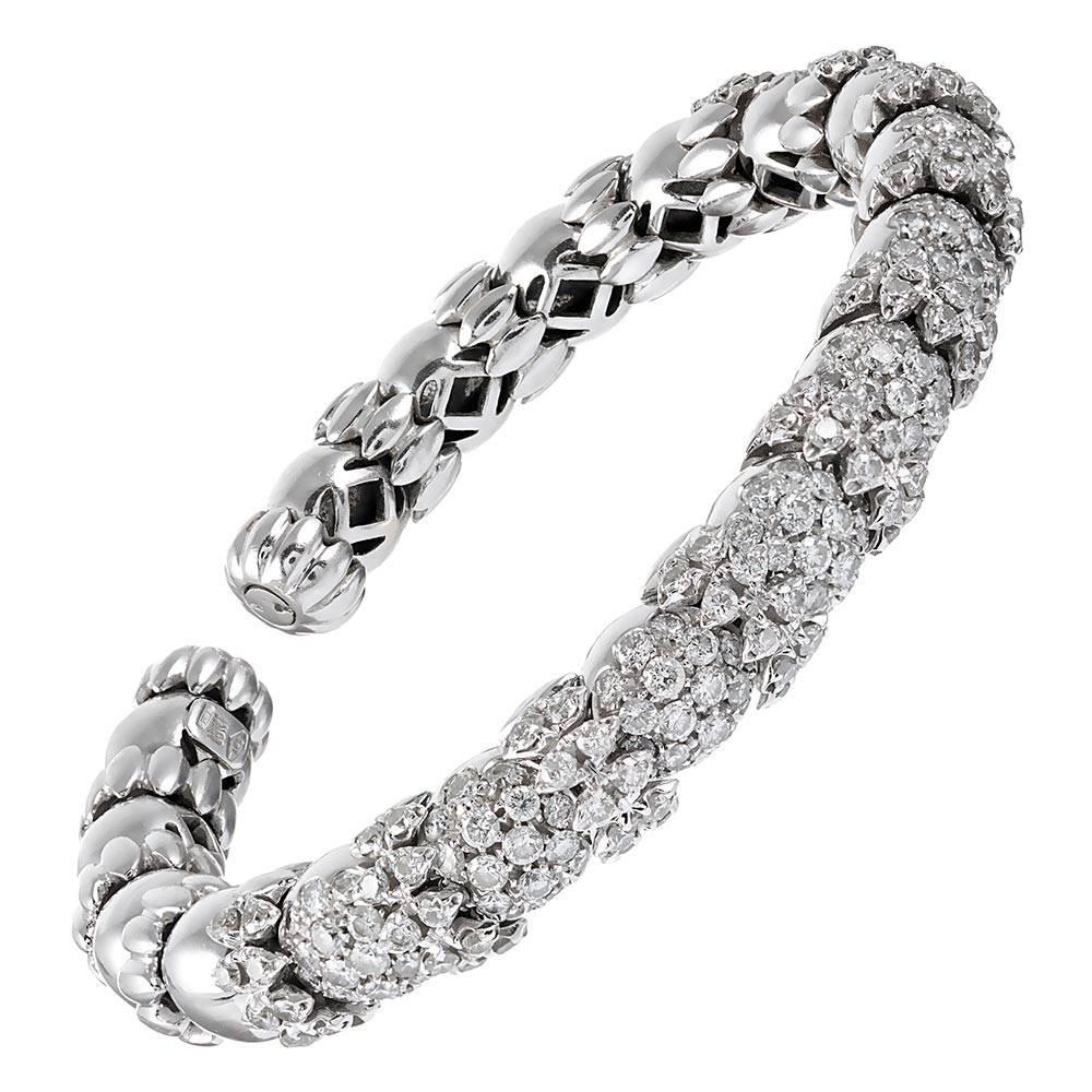 A unique design, decorated with 5.00 carats of brilliant white diamonds, the bracelet is rendered in 18 karat white gold. Flexible and comfortable, this piece is fashioned without a clasp, yet moves enough to allow you to slip your wrist inside. The