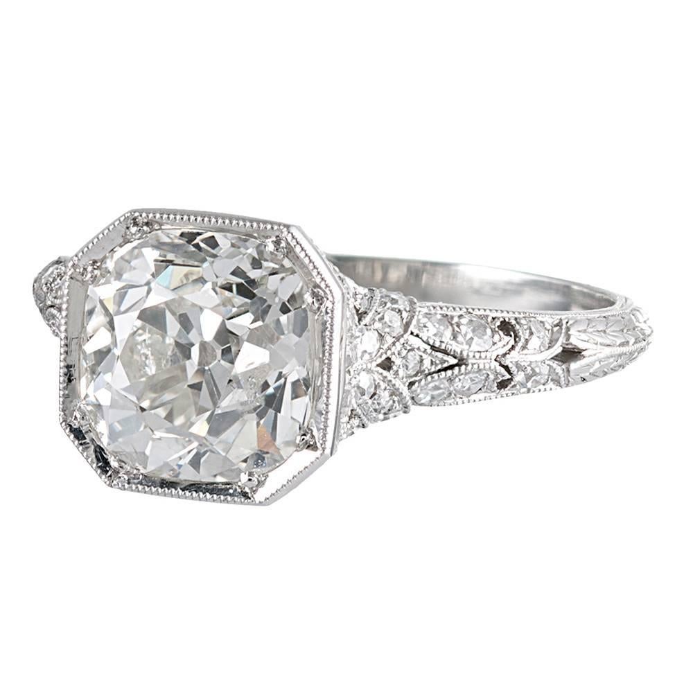 Beautifully detailed art deco design, rendered in platinum and set in the center with a 2.13 carat old mine brilliant cut diamond. The major stone exhibits I-J color and Si2-I1 clarity. The ring is accented with .50 carats of additional diamodns