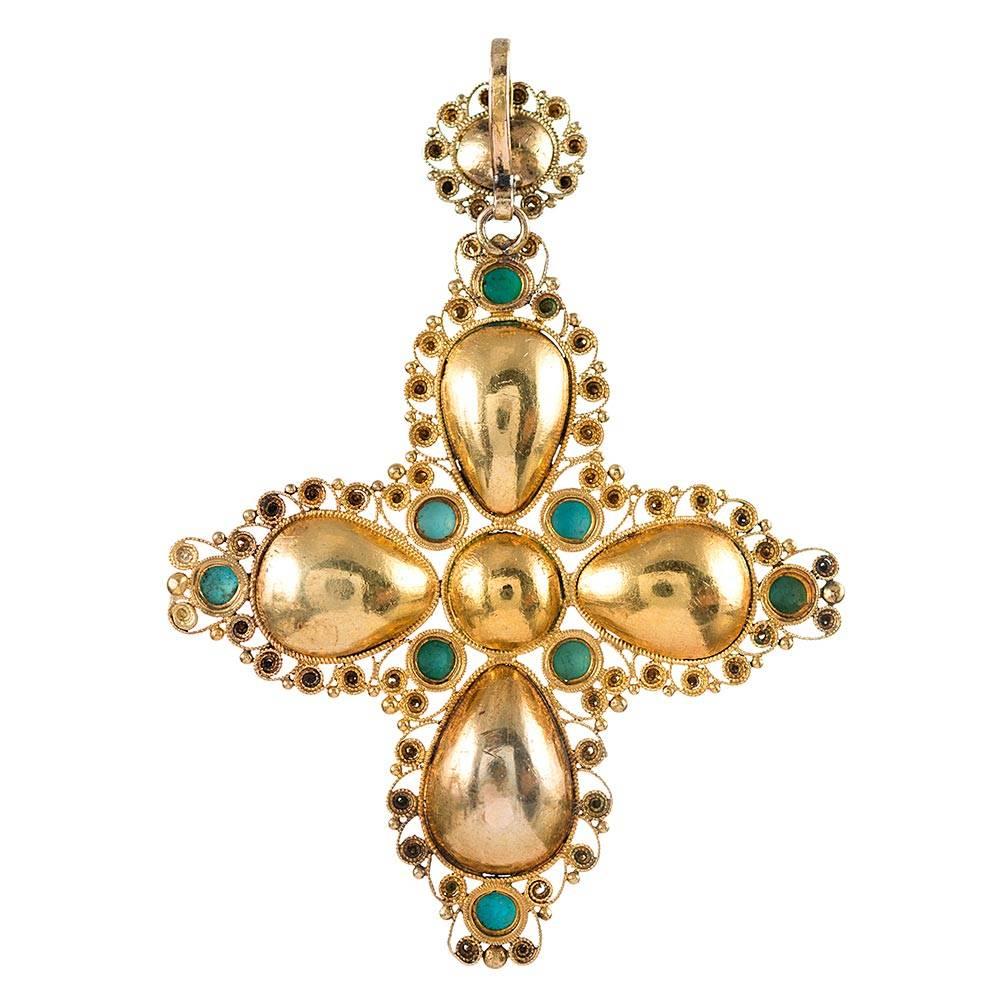 Made of 18 karat yellow gold, this substantially-sized cross pendant boasts ornate wirework that creates a unique textured backdrop for the faceted amethyst and cabochon turquoise. A fun color combination of gemstones, the piece will certainly stand