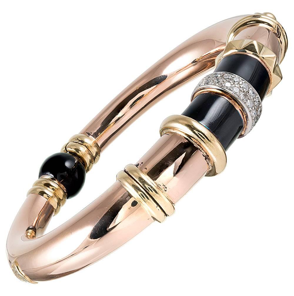The bracelet boasts bold Italian style, decorated with black onyx and brilliant white diamonds set on a backdrop of 18 karat rose gold with yellow gold accents. The slightly asymmetric design is both sophisticated and playful- the hallmark of La