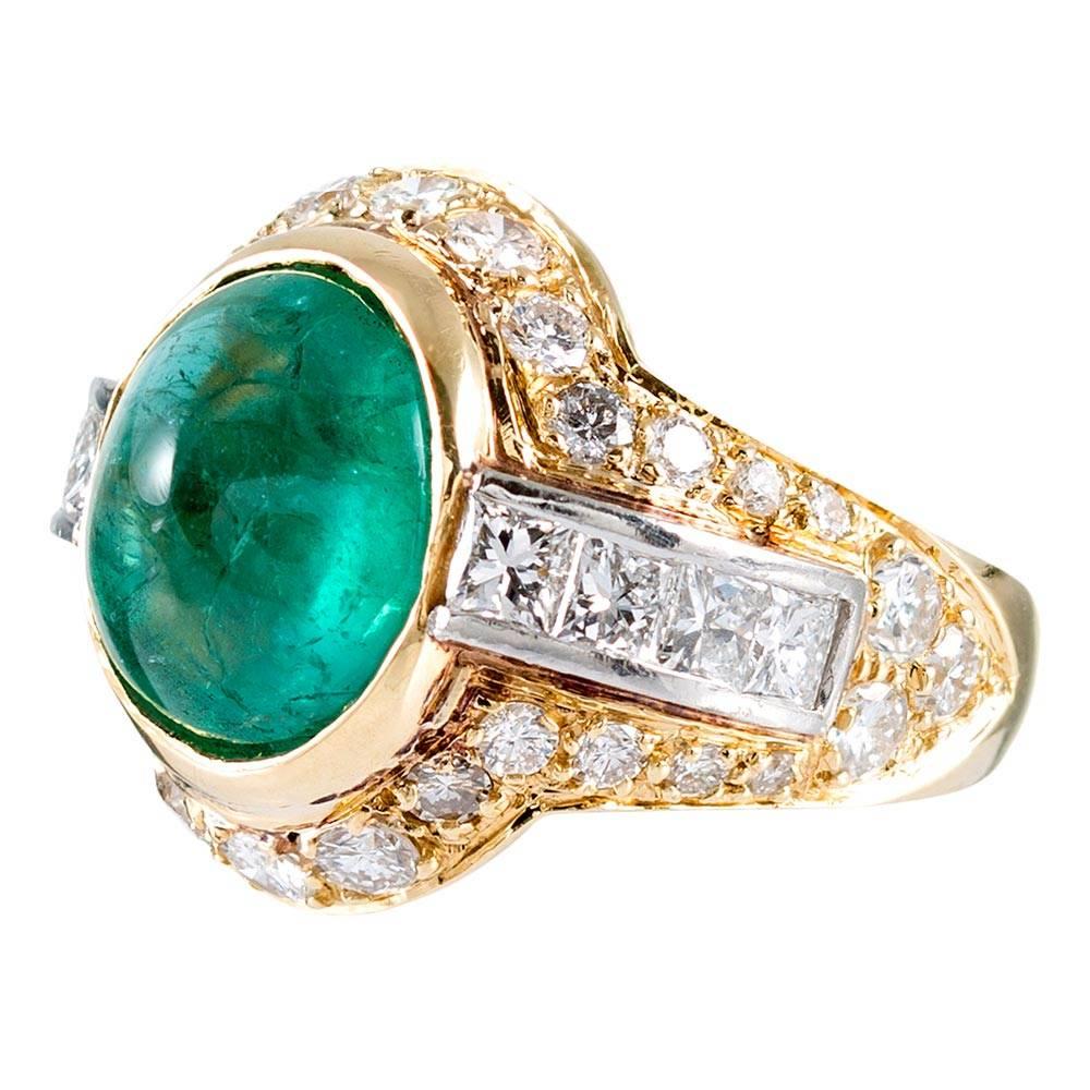 A bold contemporary design for fans of style and substance, the dome-shaped ring is set in the center with a 7 carat cabochon emerald and decorated with white diamonds. Thirty-six brilliant round and eight princess cut diamonds weigh 1.40 and 1.25