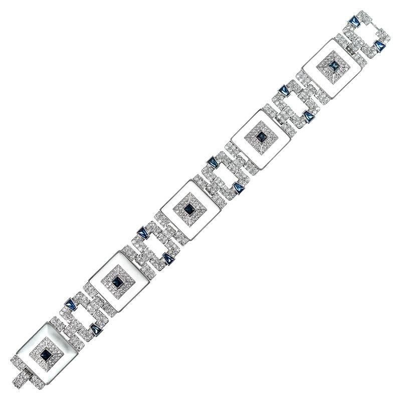 An outstanding creation with striking style elements and glamourous character, the bracelet is comprised of five rock crystal squares, each fashioned into a gentle pyramid shape and topped with brilliant diamond and intense blue sapphire accents.