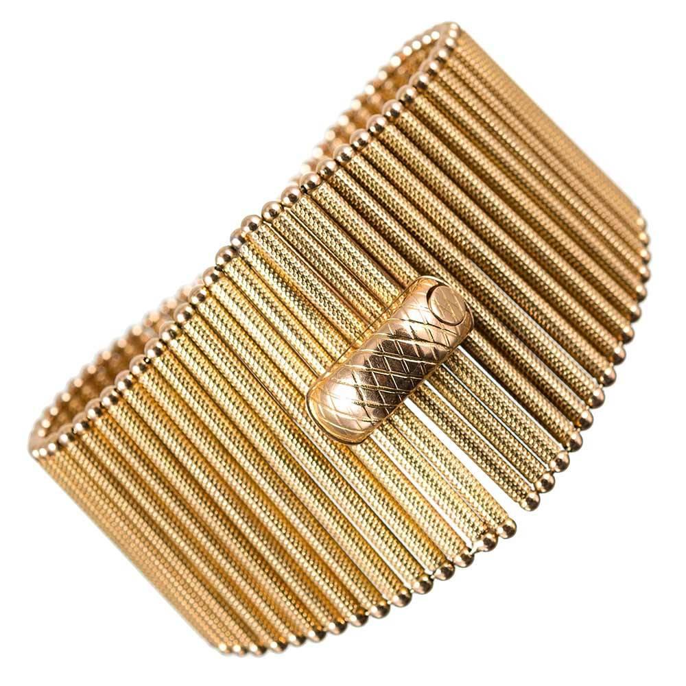 Offering monumental style, this necklace is comprised of individual tapered golden “matchsticks” that move independently and drape dramatically about the neck. The textured tubes create a fringe design that is sophisticated and unique. The