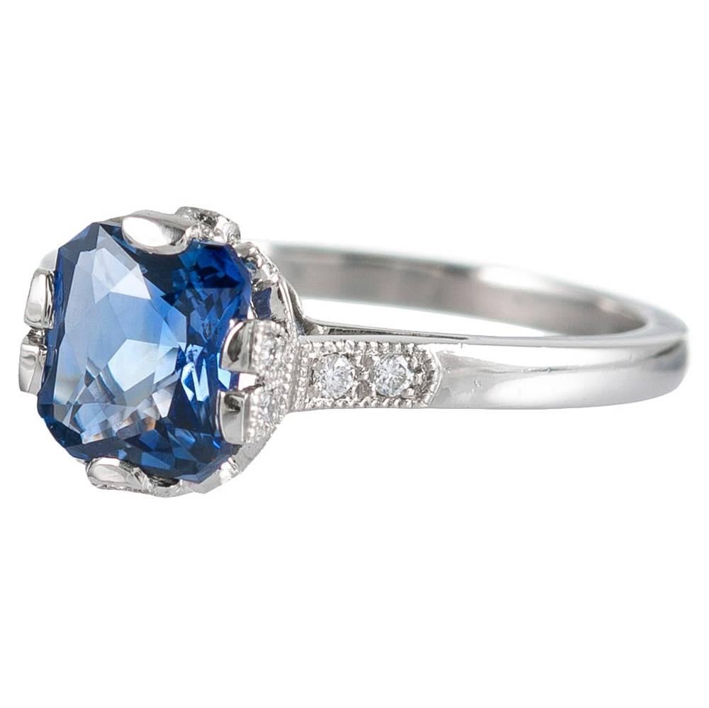 Art deco inspired finery abounds with this sweet creation, compliments of London jeweler Lucie Campbell. Rendered in platinum, the ring houses a 1.60 carat cushion-shaped cornflower blue sapphire and is decorated with .15 carats of white brilliant