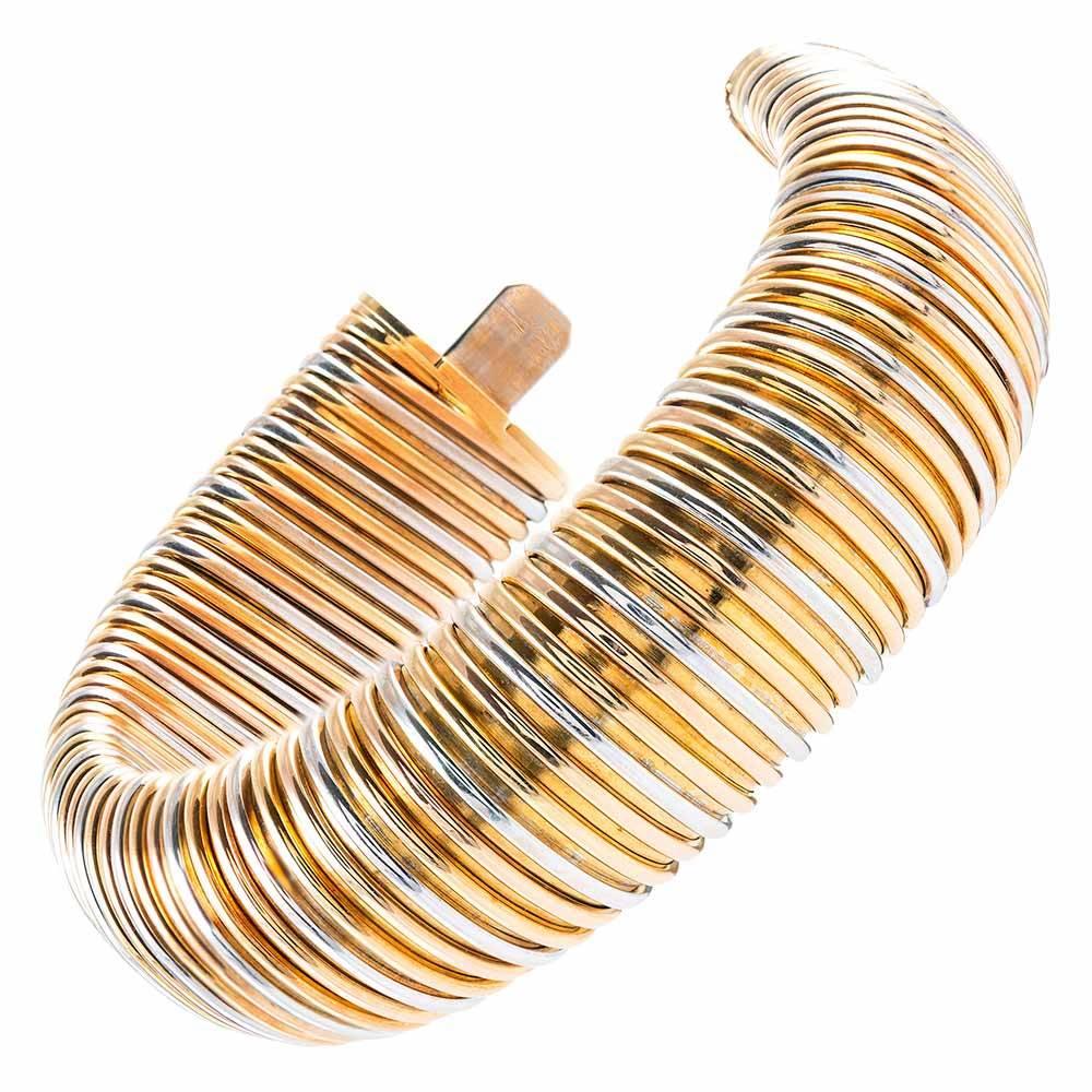 Bold and chic, this piece will compliment every article in your closet. Made of 18 karat white, yellow and rose gold, the bangle flexes gently to allow for a comfortable fit. It measures 1 inch wide and has an interior diameter of just over 2 inches.