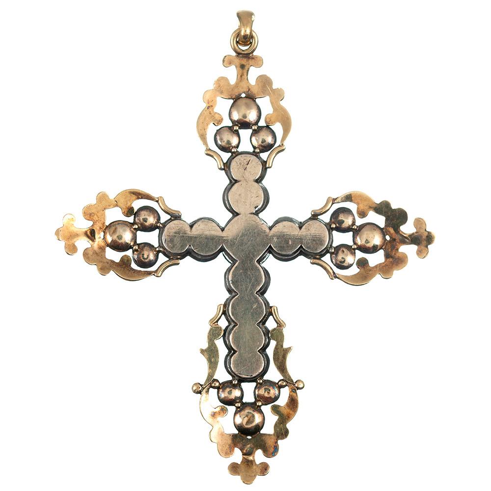 Antique finery abounds with this gold and silver antique cross. The piece is set with citrine, aquamarine and a pearl anchors the center. This impressive piece measures 3.5 by 2.75 inches. It will make a lovely addition to the collection of any