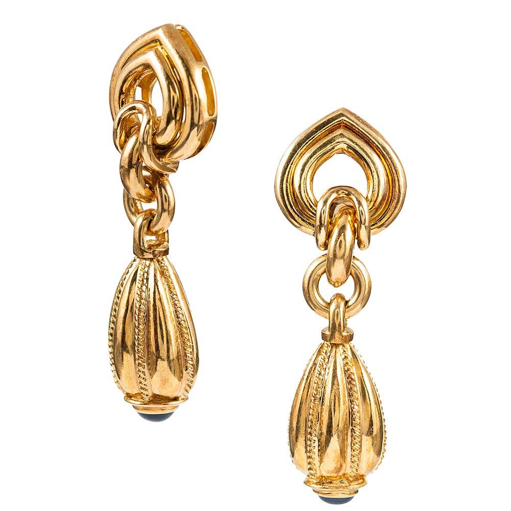 Sculpted drop earrings that highly resemble Bulgari’s iconic designs, made of 18 karat yellow gold and tipped with cabochon sapphires. The earrings measure 2.25 inches long and offer beautiful movement to compliment their polished architecture.