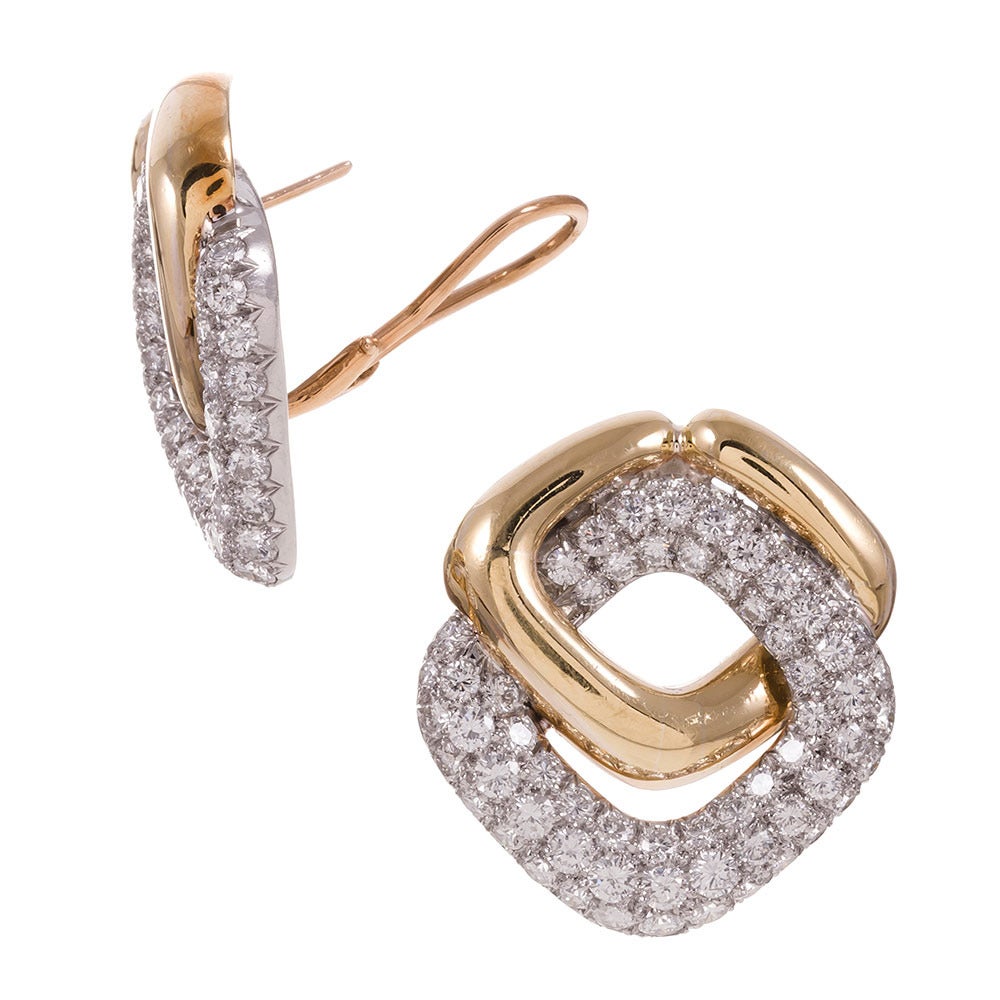 Sophisticated 1980s design, consisting of a high-polished link of 18k yellow gold, connected to a pave diamond studded link of 18k white gold. They measure 1.25 by 1 inch and are finished with a post and “Omega” style flip-up back. In total, 5.10