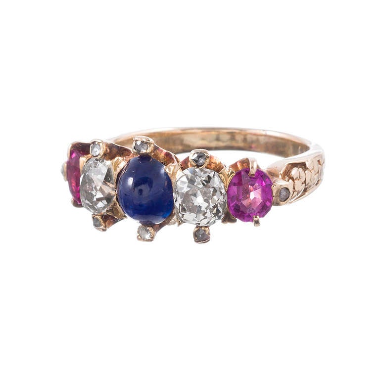 Display your patriotism in the most uncommon and subtle manner by choosing this lovely red, white and blue gemstone ring. This is a lovely Victorian piece, with a cabochon sapphire, two faceted rubies and a pair of old mine cut diamonds which weigh