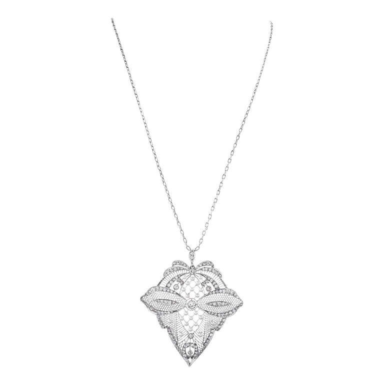 An incredible estate pendant, handmade with meticulous attention to symmetry. Crafted in platinum, the pendant measures 2 3/4 inches long by 2 1/2 inches wide. Though large, the pendant remains delicate by the utilization of hand piercing throughout