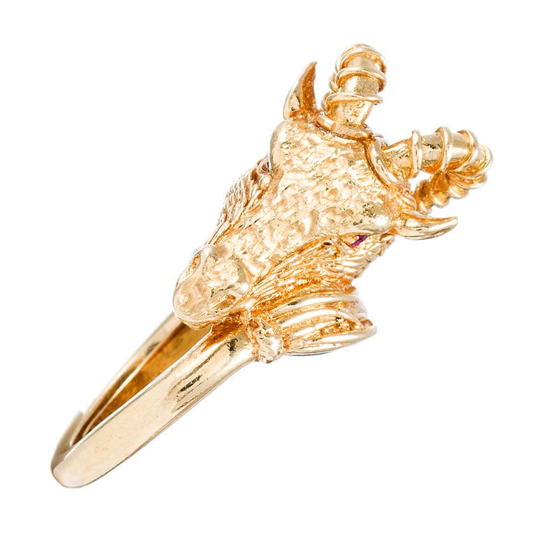 18k yellow gold ring with lovely organic texture, formed into the shape of a ram's head and finished with ruby eyes. The ring rises approximately 3/4 of an inch off the finger and is 3/4 of an inch wide at its widest point. It can be resized for you